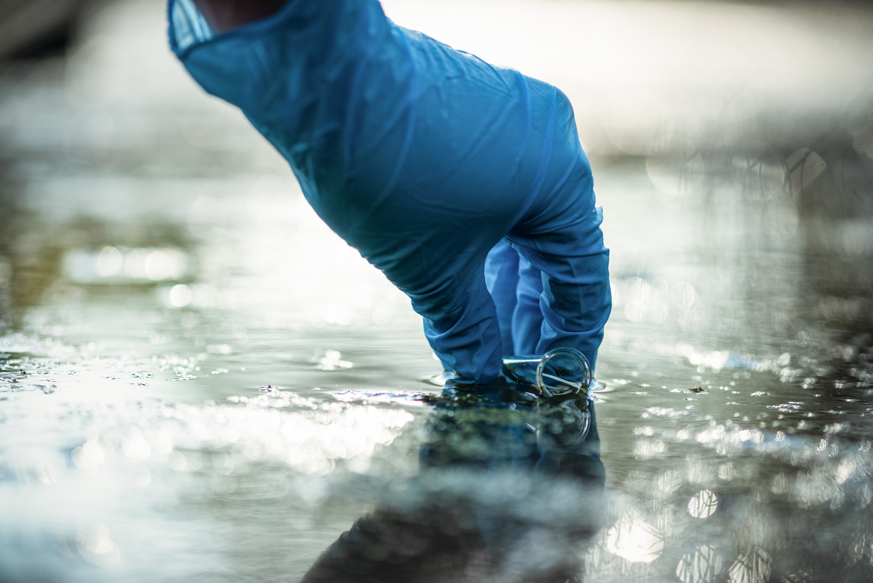 Sampling water for chemical testing.