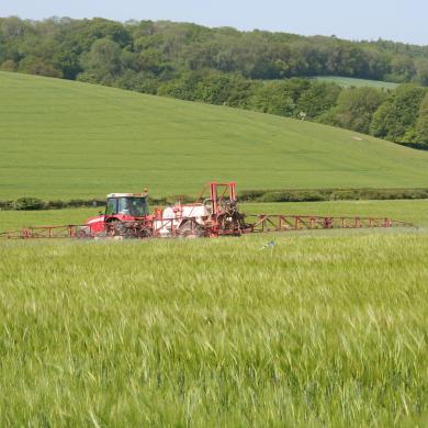 Tractor spraying crops