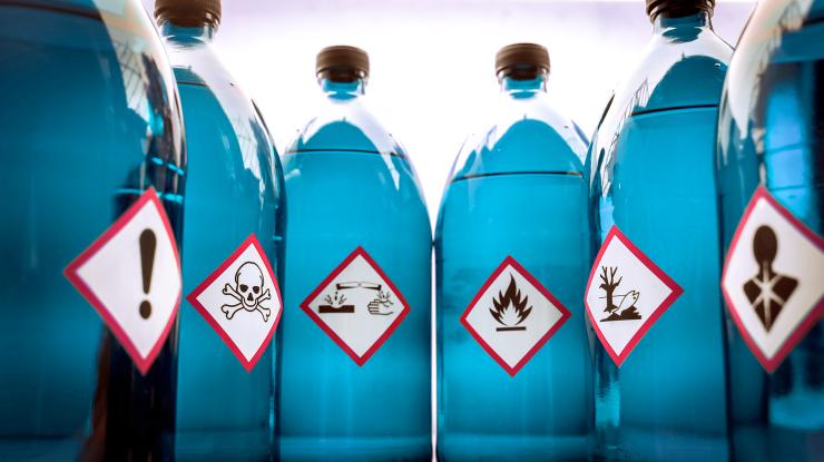 Chemical Hazard Labels on Blue Bottles